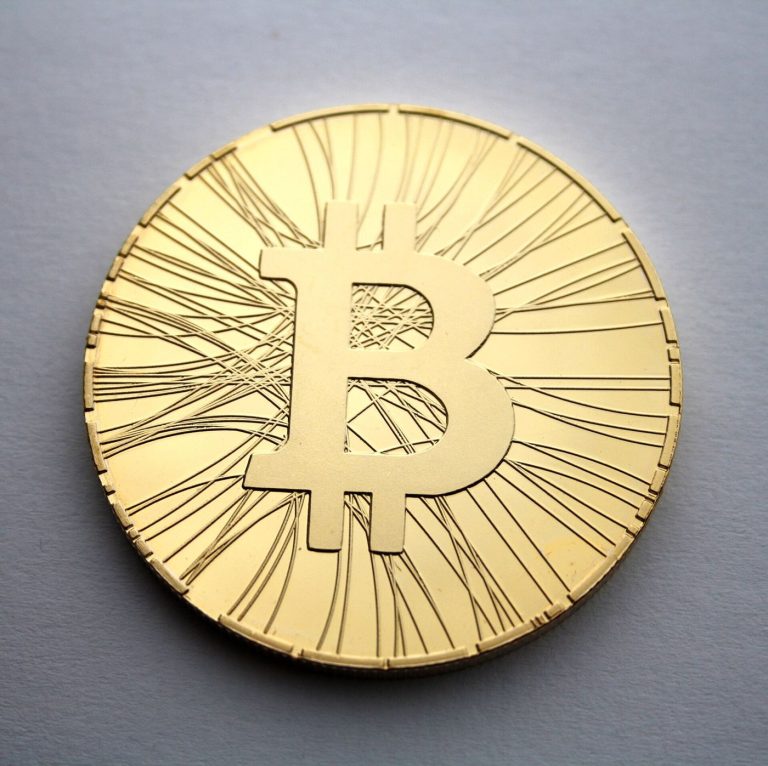 Bitcoin Funds Draw Institutions Into Crypto Markets Physical bitcoin tokens arranged on a dark surface